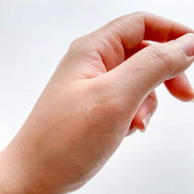 V コントア セラムを手の甲に伸ばしている写真。軽やかにのびて、肌になじませることでフェイスラインがキュッと引き締まるような感覚が期待できる美容液。